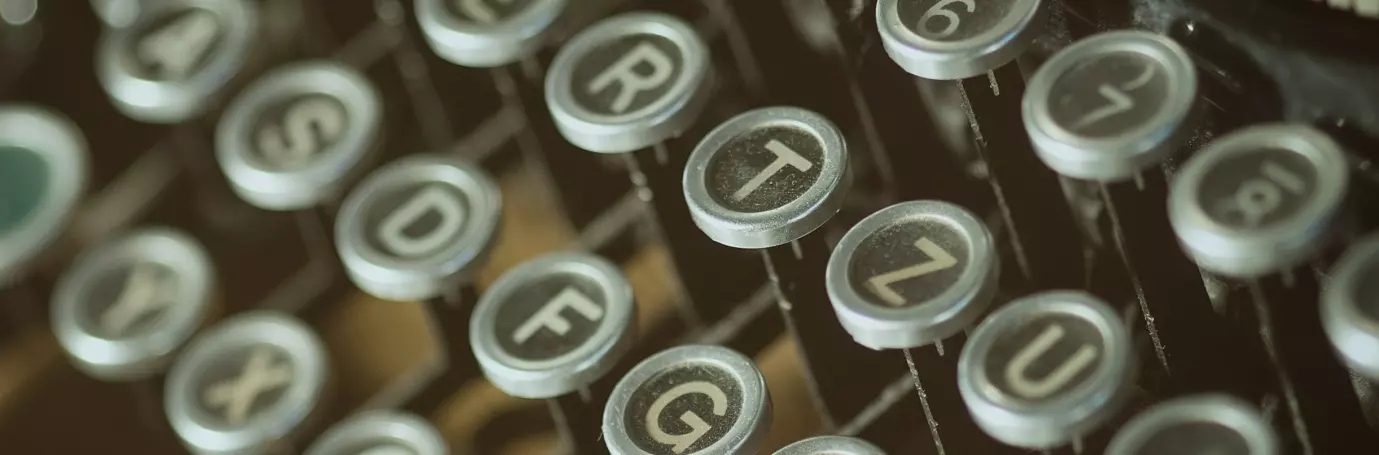 Typewriter keys, illustrating the process of writing up a consulting resume