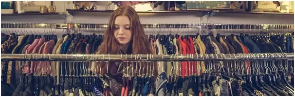 Young woman browsing clothing, illustrating a PST worked example question on a clothing retailer